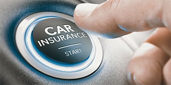 A person is pressing a car insurance button on a car