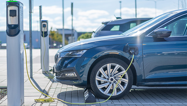 An electric car is being charged at a charging station