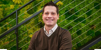 Image of Andy Oury sitting outside on stairs.