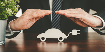 A person is pressing a car insurance button on a car