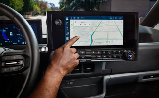 A person using the navigation on the touch display of a Chevrolet BrightDrop