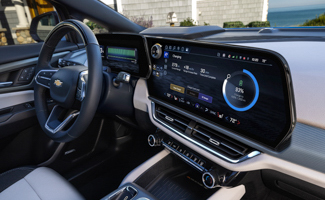 A close up of the interior of a Chevrolet Equinox EV with a dashboard and steering wheel