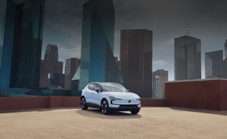 A white Volvo EX30 parked on a roof with cityscape behind