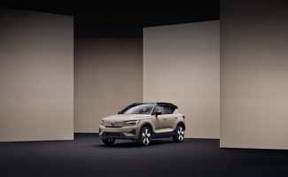 A tan Volvo EX40 parked inside a tan building