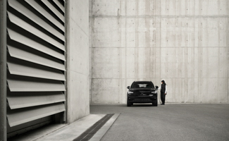 A black Volvo EX40 parked outside a building