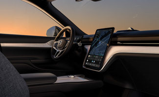 The interior of the steering wheel and dashboard of a Volvo EX90 at sunset