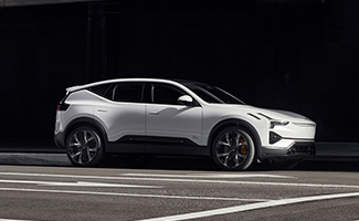 a white Polestar 3 driving down a road
