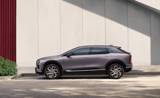 Gray Cadillac OPTIQ parked in front of a wall
