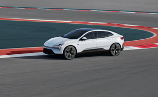 A white Polestar 4 on a race track curve